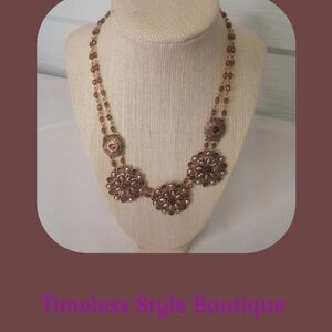 Gold and clear costume jewelry necklace.